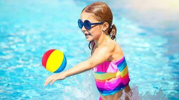 Little girl playing in the pool photo