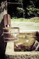 old well and wooden bucket photo