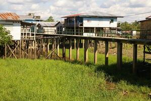 Houses on stilts rise above the polluted water in Islandia Peru photo