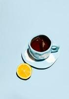 Lemon tea cup with teabag and lemon fruit. photo