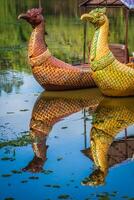 Thai traditional  boats on the lake near,Bayon temple in Angkor Thom, Siemreap, Cambodia. photo