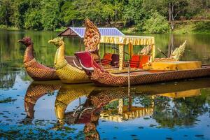 Thai traditional  boats on the lake near,Bayon temple in Angkor Thom, Siemreap, Cambodia. photo