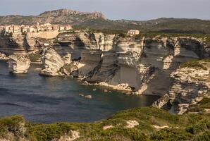 Beautiful old village of Bonifacio Corsica island, France suspended over amazing cliffs photo