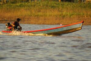 On the way of going fishing in Amazon jungle river, during the late of afternoon, in Brazil. photo