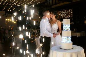 newlyweds happily cut and taste the wedding cake photo