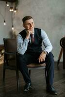 portrait of a cheerful groom in a blue suit photo