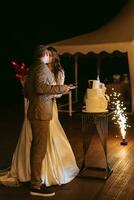 newlyweds happily cut and taste the wedding cake photo