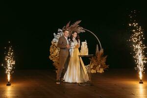 newlyweds happily cut and taste the wedding cake photo