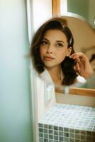 brown-haired girl in the morning in the bathroom photo