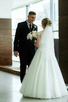 meeting of the bride and groom in the hotel lobby photo