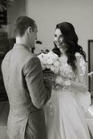 meeting of the bride and groom on the hotel stairs photo