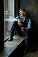 portrait of a cheerful groom in a blue suit photo