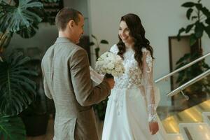 meeting of the bride and groom on the hotel stairs photo