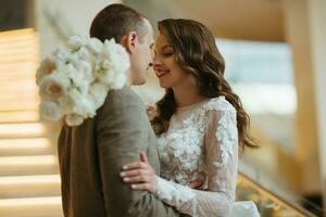 meeting of the bride and groom on the hotel stairs photo