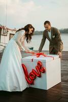 bride and groom opening a wedding gift photo