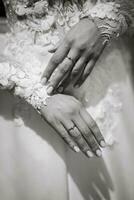 the bride holds her tenderly and touches the engagement ring photo