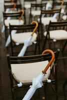 white umbrellas from rain and sun with wooden handles photo