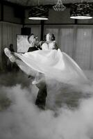 the first dance of the bride and groom inside a restaurant photo