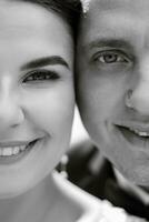 the groom in a brown suit and the bride in a white dress photo