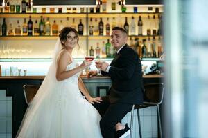 bride and groom inside a cocktail bar photo