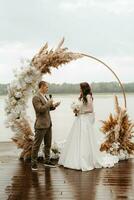 wedding ceremony of the newlyweds on the pier photo