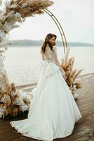 bride against the background of a yellow sunset photo