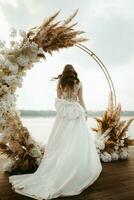 bride against the background of a yellow sunset photo