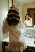 brown-haired girl in the morning in the bathroom photo