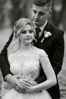 the groom and the bride are walking in the forest photo