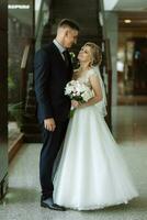 meeting of the bride and groom in the hotel lobby photo