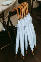 white umbrellas from rain and sun with wooden handles photo