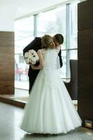 meeting of the bride and groom in the hotel lobby photo