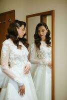 brown-haired girl puts on a wedding dress photo