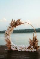 wedding round arch against the background of a river photo