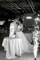 newlyweds happily cut and taste the wedding cake photo