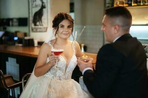 bride and groom inside a cocktail bar photo