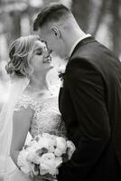 the groom and the bride are walking in the forest photo