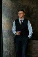 portrait of a cheerful groom in a blue suit photo