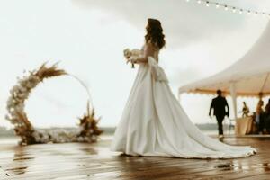 bride against the background of a yellow sunset photo