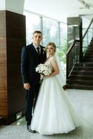 meeting of the bride and groom in the hotel lobby photo