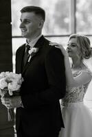 meeting of the bride and groom in the hotel lobby photo