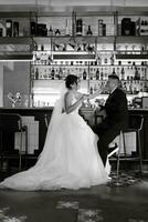 bride and groom inside a cocktail bar photo