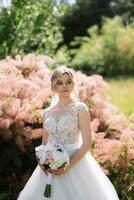 young girl bride in a white dress in a spring forest photo