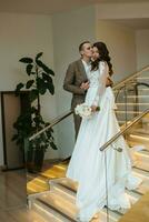 meeting of the bride and groom on the hotel stairs photo