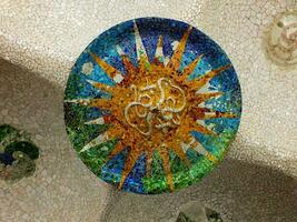 Ceiling with colorful mosaic sun detail at Park Guell, Barcelona, Spain. photo