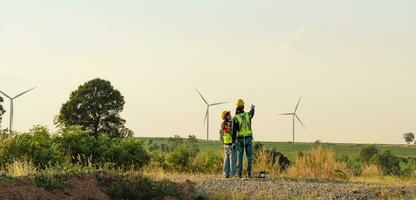 Engineers are working with wind turbines, Green ecological power energy generation, and sustainable windmill field farms. Alternative renewable energy for clean energy concept. photo