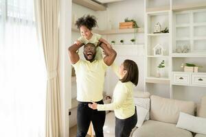 Happy Family Of Three With Little Daughter Having Fun Together At Home, Happy black family Weekend. photo