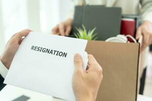 resignation, leave, quit, Business oner read resignation letter from employee. staff is lifting a brown paper box that holds personal items. , job placement and vacancies, resignation letter photo