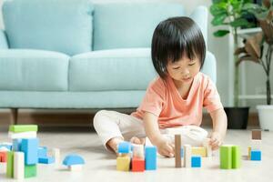 Happy Asia children play and learn toy blocks.family is happy and excited in the house. daughter having fun spending time, Activity, development, IQ, EQ, meditation, brain, muscles, essential skills. photo