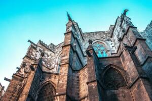 Photo of cathedral in the old Gothic Quarter, Barcelona, Catalonia. Side view of medieval wall in Catalonia